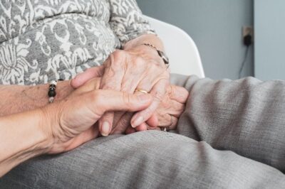 Older adult holding hand